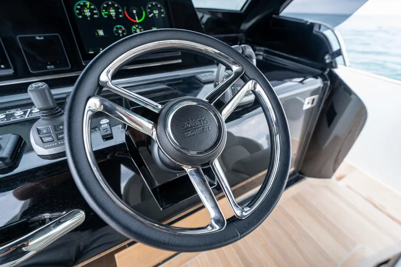 Slide: The Image of Steering wheel of 2026 Solaris Power 44 Sport Turismo yacht, featuring modern dashboard controls. - 14
