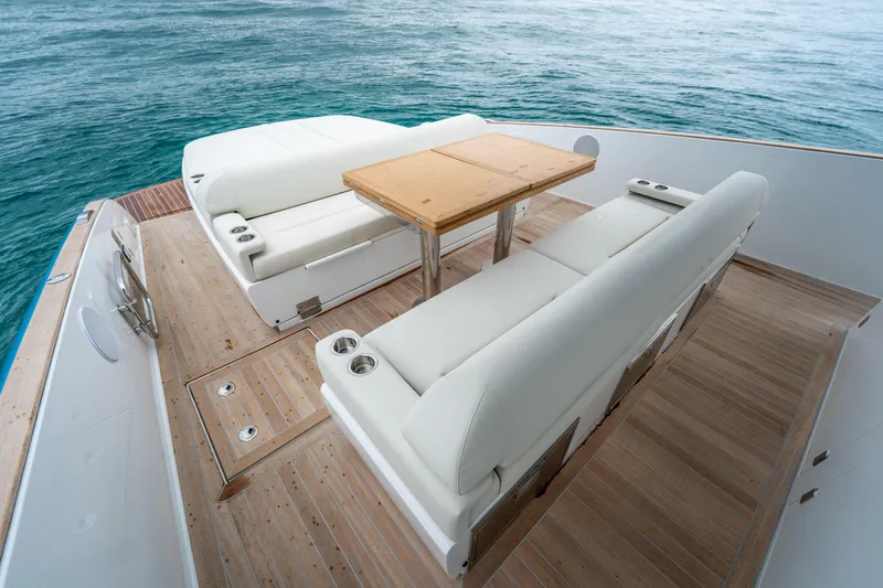 Slide: The Image of 2026 Solaris Power 44 Sport Turismo yacht deck with white seating and wooden table. - 26