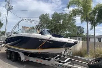 The Image of 2014 Cobalt 240SD boat on trailer, parked outdoors near palm trees. - 0