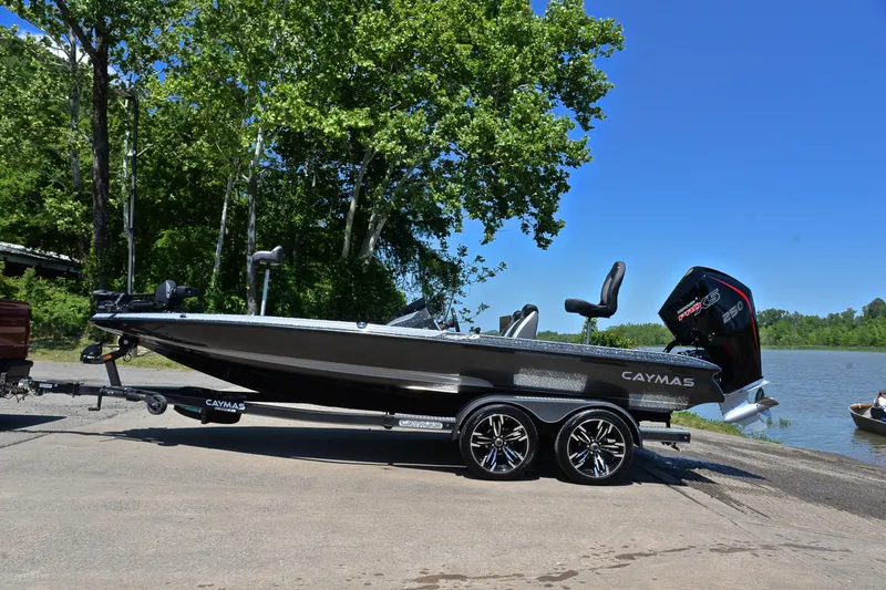 Slide: The Image of 2022 Caymas CX 20 boat on trailer by a lake, surrounded by trees. - 10