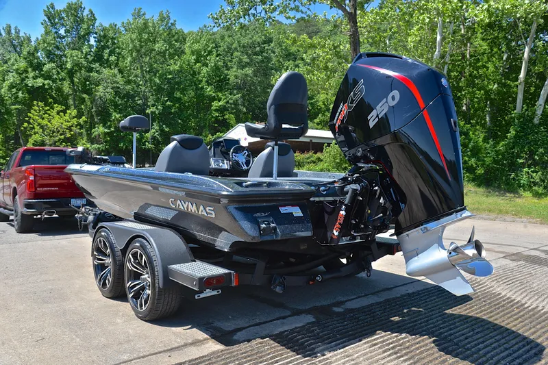 Slide: The Image of 2022 Caymas CX 20 boat with powerful engine on trailer, parked outdoors. - 11