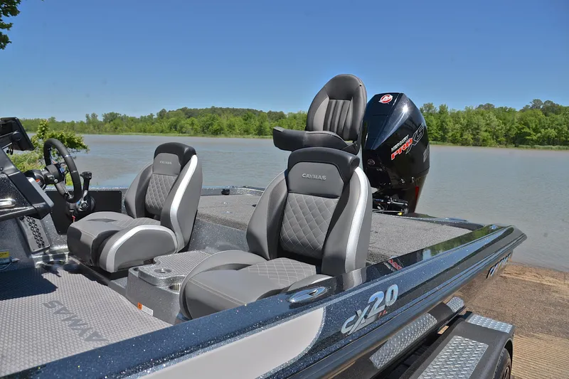 Slide: The Image of 2022 Caymas CX 20 boat with sleek seating, docked by a serene lake. - 17