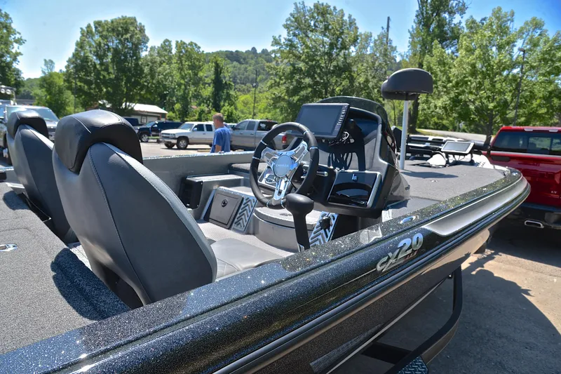 Slide: The Image of 2022 Caymas CX 20 boat interior with steering wheel and dashboard, parked outdoors. - 18