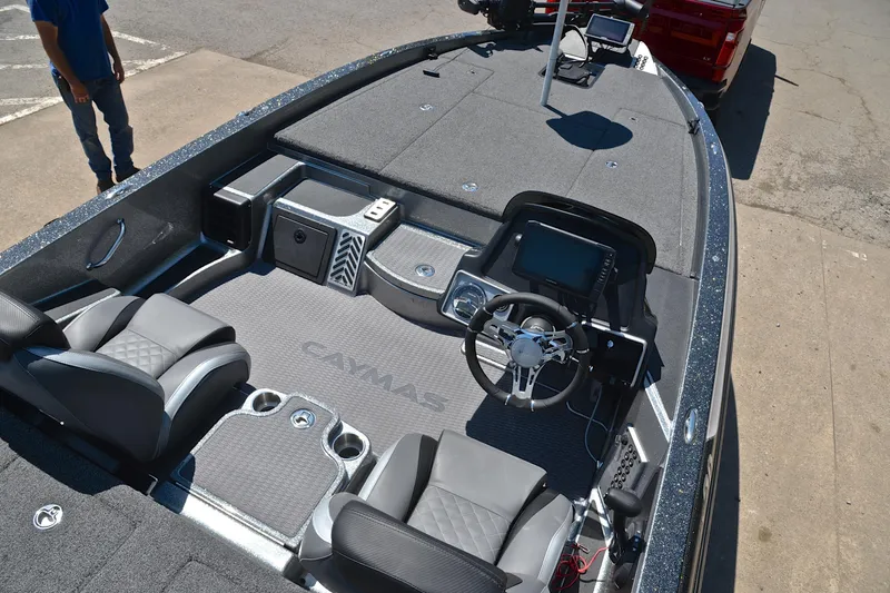 Slide: The Image of 2022 Caymas CX 20 boat interior with steering wheel, seats, and control panel. - 19