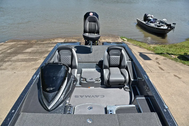 Slide: The Image of 2022 Caymas CX 20 boat interior with seats, docked by a lake. - 21