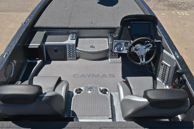 Slide: The Image of 2022 Caymas CX 20 boat interior with dual seats, steering console, and modern dashboard. - 22