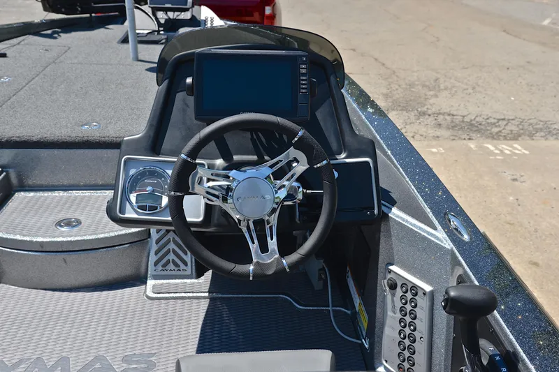 Slide: The Image of 2022 Caymas CX 20 boat dashboard with steering wheel and electronic display. - 23