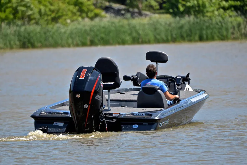 Slide: The Image of 2022 Caymas CX 20 boat cruising on a calm lake with lush greenery. - 7