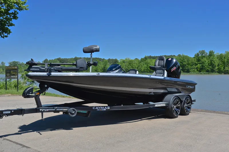Slide: The Image of 2022 Caymas CX 20 boat on trailer by a lake, clear blue sky. - 9