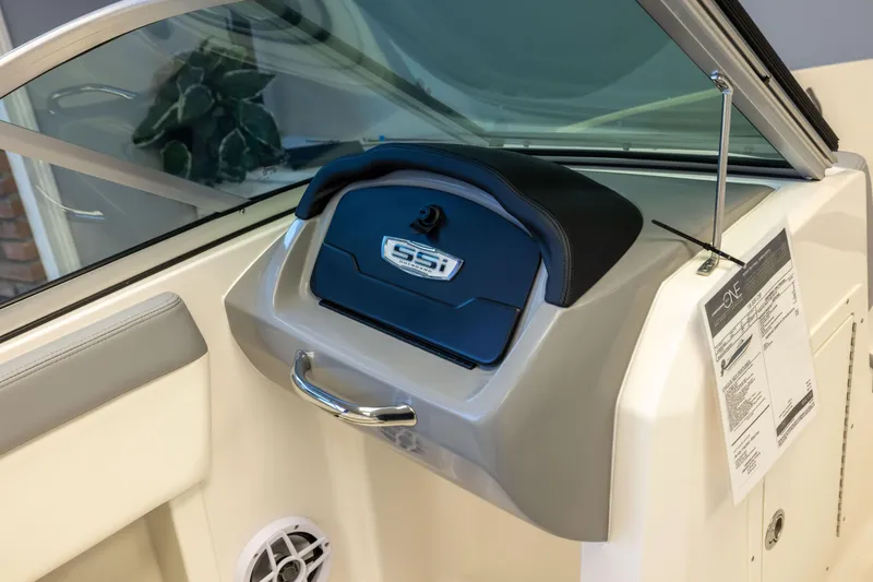 Slide: The Image of 2024 Chaparral 19 SSi OB boat dashboard with glove compartment and speaker. - 11
