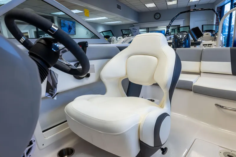 Slide: The Image of 2024 Chaparral 19 SSi OB boat interior with steering wheel and white seating. - 13