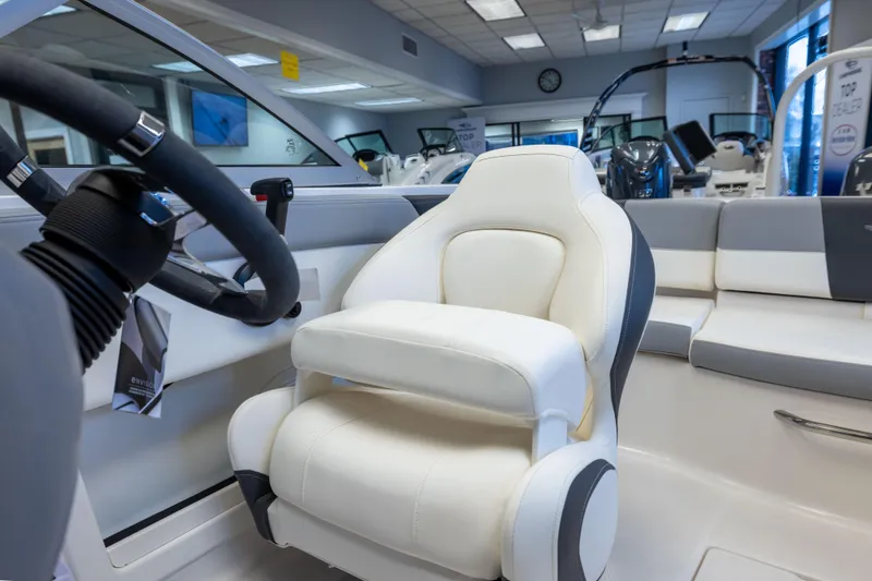 Slide: The Image of 2024 Chaparral 19 SSi OB boat interior with white captain's seat and steering wheel. - 14