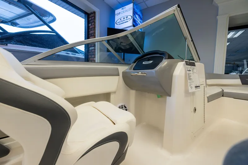 Slide: The Image of 2024 Chaparral 19 SSi OB boat interior with sleek seating and modern dashboard design. - 16