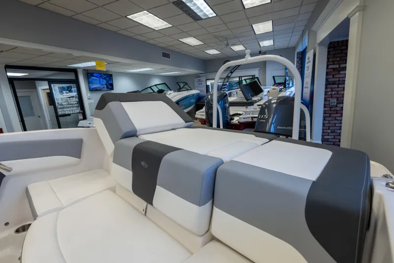Slide: The Image of 2024 Chaparral 19 SSi OB boat interior with sleek seating in showroom. - 17