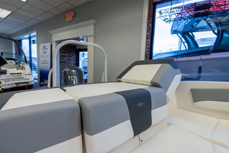Slide: The Image of 2024 Chaparral 19 SSi OB boat interior with stylish seating in a showroom. - 18