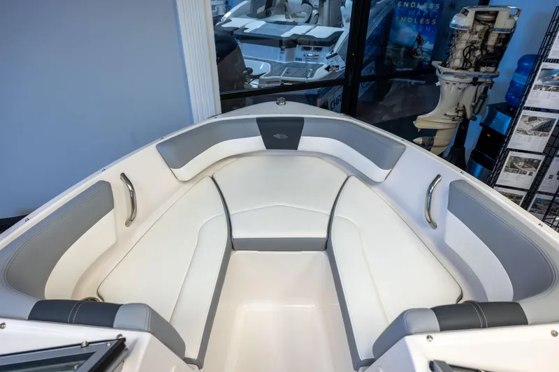 Slide: The Image of 2024 Chaparral 19 SSi OB boat interior with white and gray seating. - 19