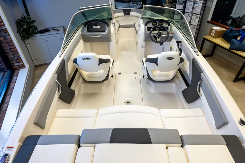 Slide: The Image of 2024 Chaparral 19 SSi OB boat interior with modern seating and steering console. - 3