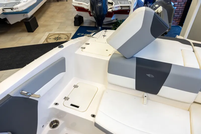 Slide: The Image of 2024 Chaparral 19 SSi OB boat interior with gray and white seating in showroom. - 5
