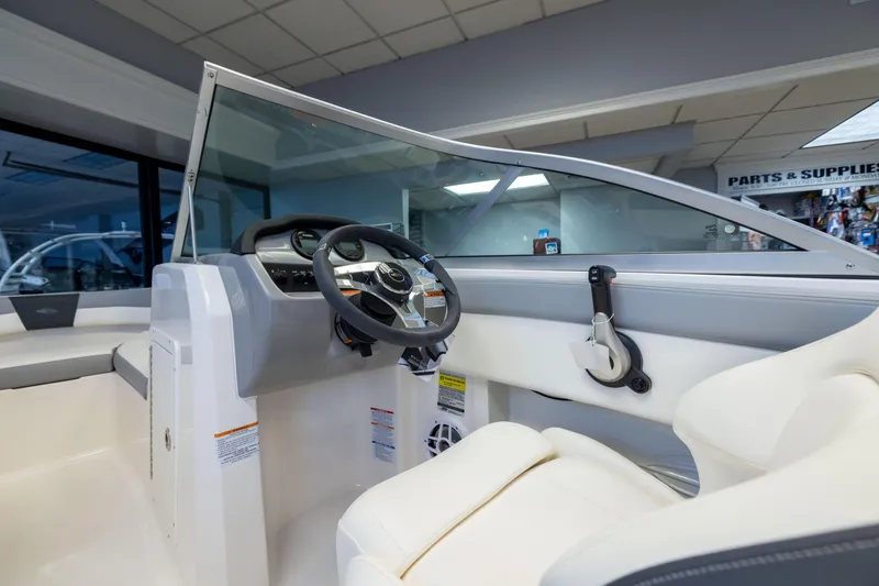 Slide: The Image of 2024 Chaparral 19 SSi OB boat interior with steering wheel and controls. - 8
