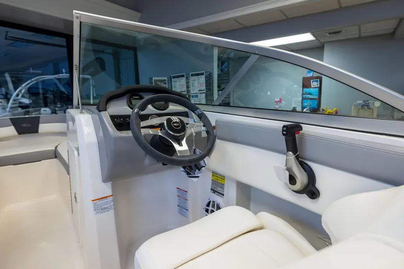 Slide: The Image of 2024 Chaparral 19 SSi OB boat interior with steering wheel and control panel. - 9