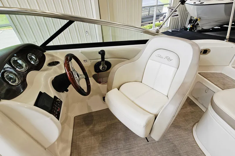 Slide: The Image of Interior of a 2012 Sea Ray 200 Sundeck boat, featuring a sleek captain's chair and dashboard. - 10