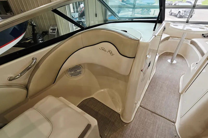 Slide: The Image of Interior of a 2012 Sea Ray 200 Sundeck boat, featuring seating and helm area. - 13