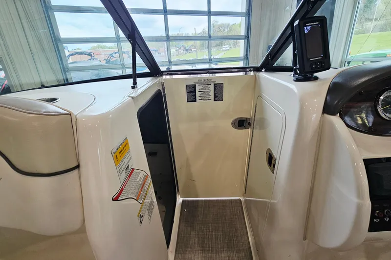 Slide: The Image of Interior view of a 2012 Sea Ray 200 Sundeck boat cockpit with control panel. - 21