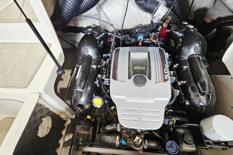 Slide: The Image of Engine compartment of a 2012 Sea Ray 200 Sundeck boat, featuring a MerCruiser 5.0 MPI engine. - 23
