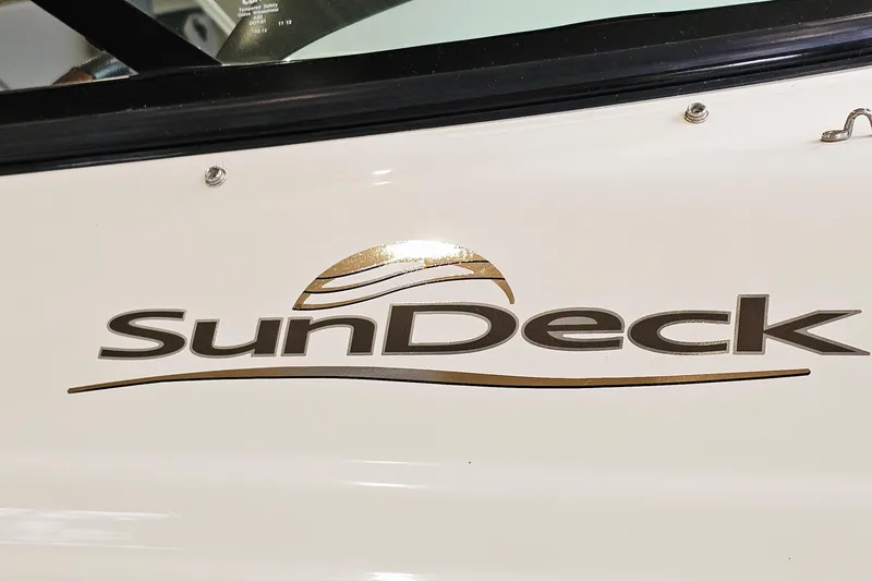 Slide: The Image of Close-up of 2012 Sea Ray 200 Sundeck logo on boat exterior. - 26