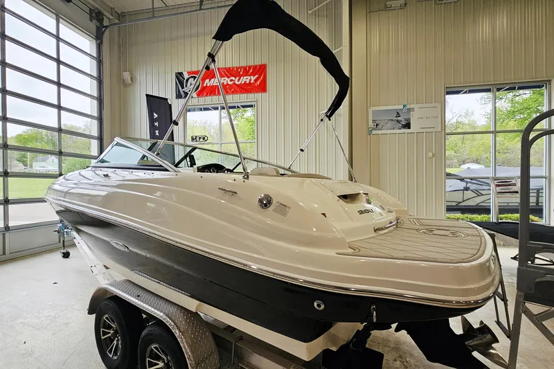 Slide: The Image of 2012 Sea Ray 200 Sundeck boat on trailer in indoor showroom. - 3