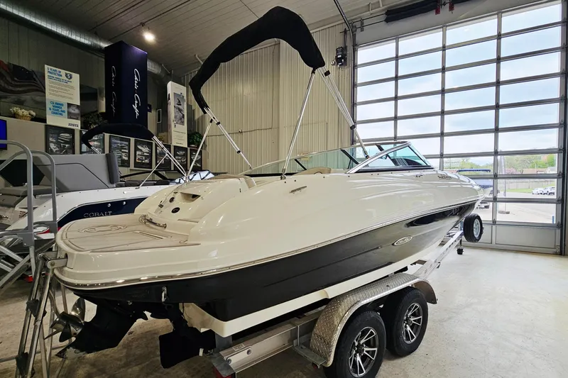 Slide: The Image of 2012 Sea Ray 200 Sundeck boat on trailer in showroom. - 4