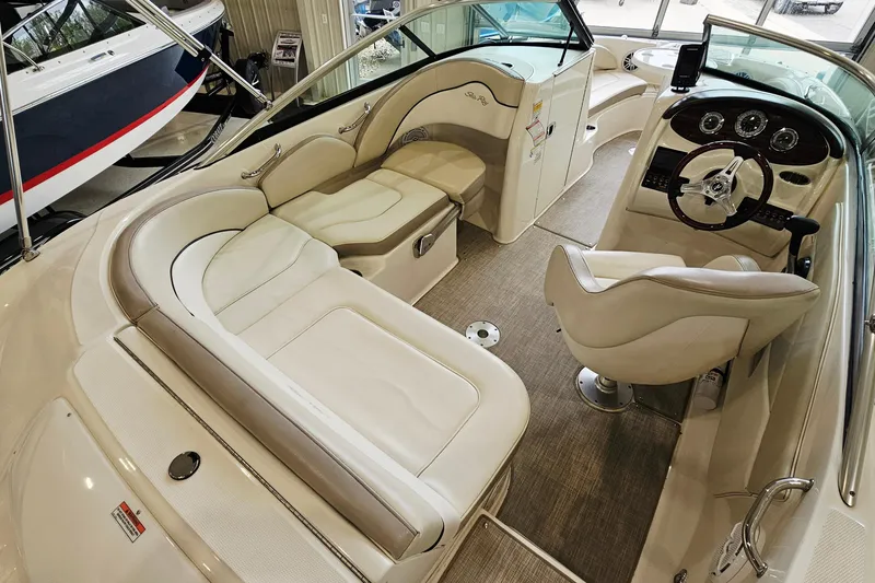 Slide: The Image of Interior of a 2012 Sea Ray 200 Sundeck boat with plush seating and modern dashboard. - 7