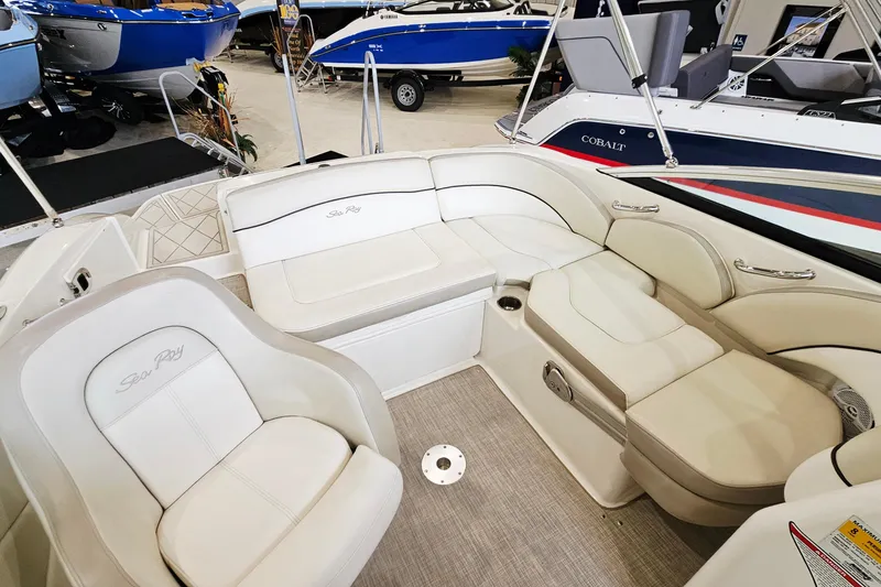 Slide: The Image of 2012 Sea Ray 200 Sundeck interior with white seating and elegant design. - 8