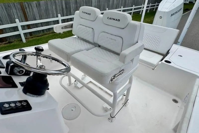 Slide: The Image of 2023 Caymas 26 HB boat interior with dual white cushioned seats and steering wheel. - 10