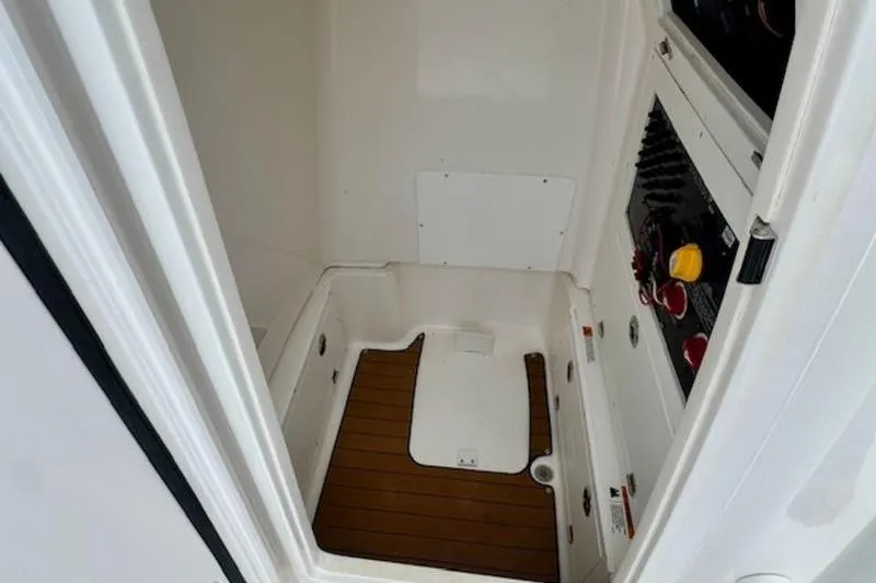 Slide: The Image of 2023 Caymas 26 HB boat interior with wood flooring and control panel. - 14