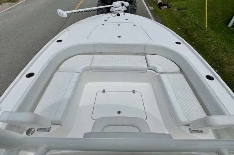 Slide: The Image of 2023 Caymas 26 HB boat interior with cushioned seating and storage compartments. - 15