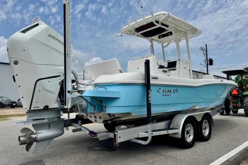 Slide: The Image of 2023 Caymas 26 HB boat on trailer, featuring a powerful Mercury outboard motor. - 4