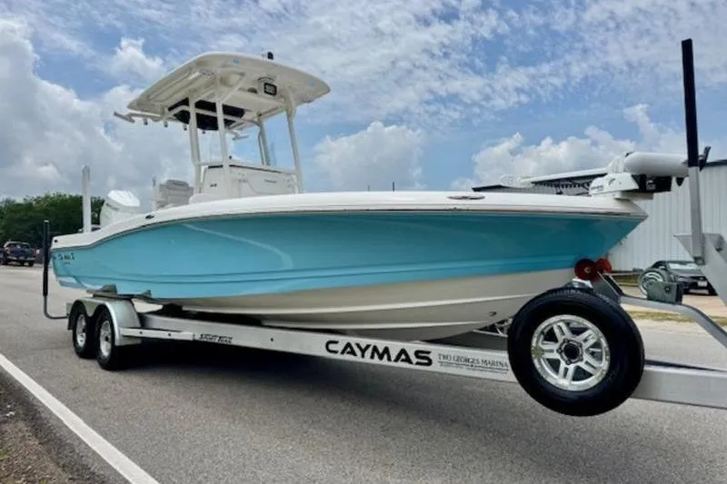 Slide: The Image of 2023 Caymas 26 HB boat on trailer, featuring sleek design and vibrant blue hull. - 6