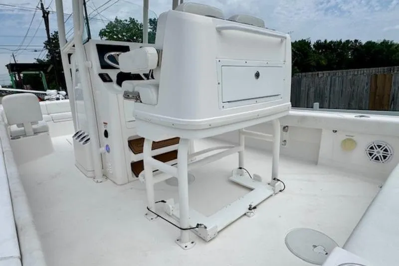 Slide: The Image of 2023 Caymas 26 HB boat interior with white seating and console. - 9