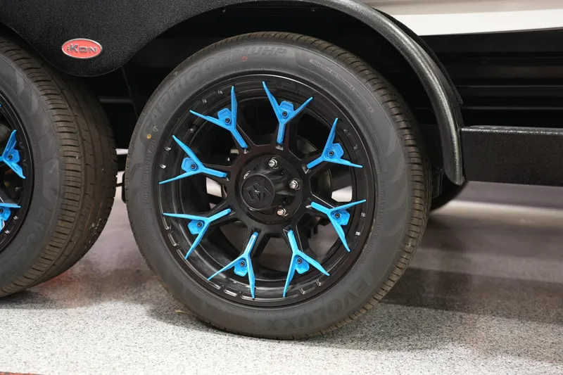 Slide: The Image of Blue-accented wheel of 2026 iKon VLE21 vehicle on display. - 2