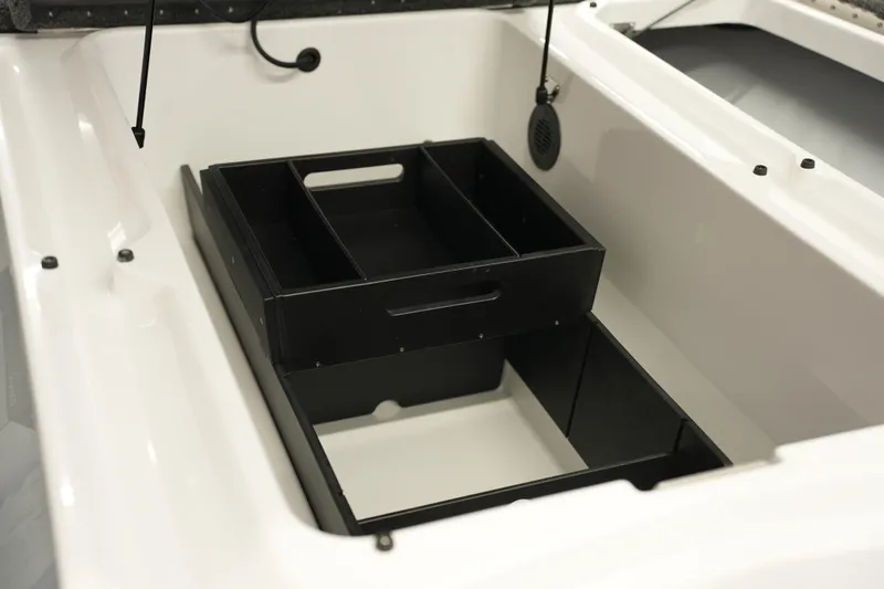 Slide: The Image of 2026 iKon VLE21 boat storage compartment with black organizer tray. - 20