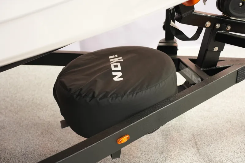 Slide: The Image of Trailer hitch with iKon VLE21 tire cover, 2026 model, on a textured surface. - 7