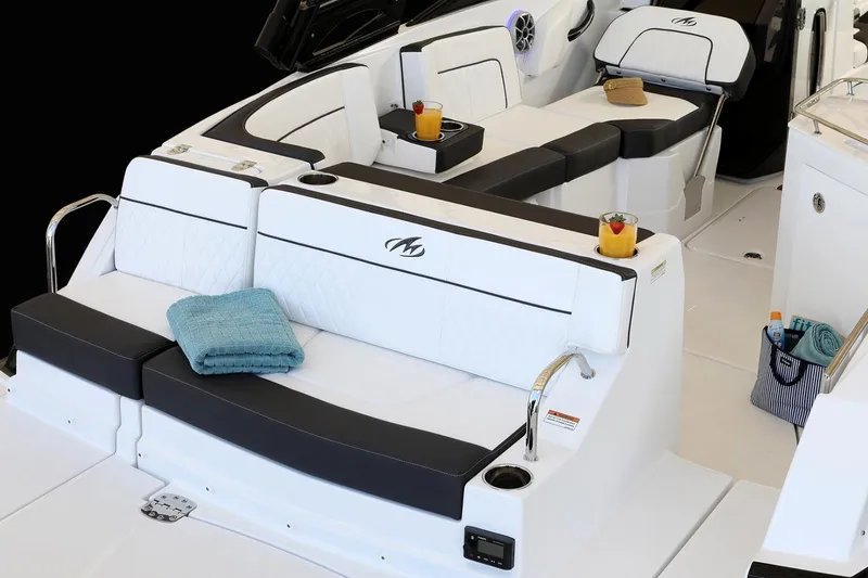 Slide: The Image of Manufacturer Provided Image: Luxurious seating on 2026 Monterey M-65 boat with drinks and towels. - 11