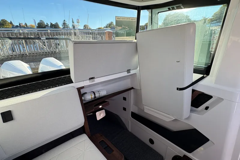 Slide: The Image of 2026 Axopar 29 XC Cross Cabin interior with modern seating and window view. - 14
