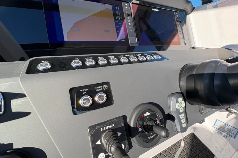 Slide: The Image of Control panel of 2026 Axopar 29 XC Cross Cabin with navigation screens and switches. - 19