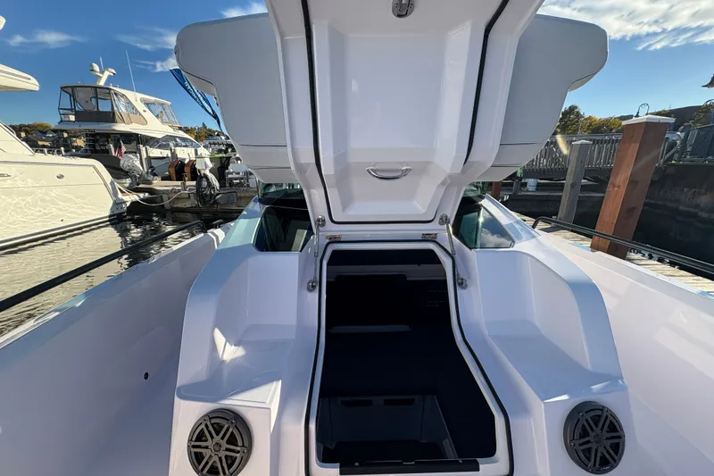 Slide: The Image of 2026 Axopar 29 XC Cross Cabin boat interior with open hatch at marina. - 11