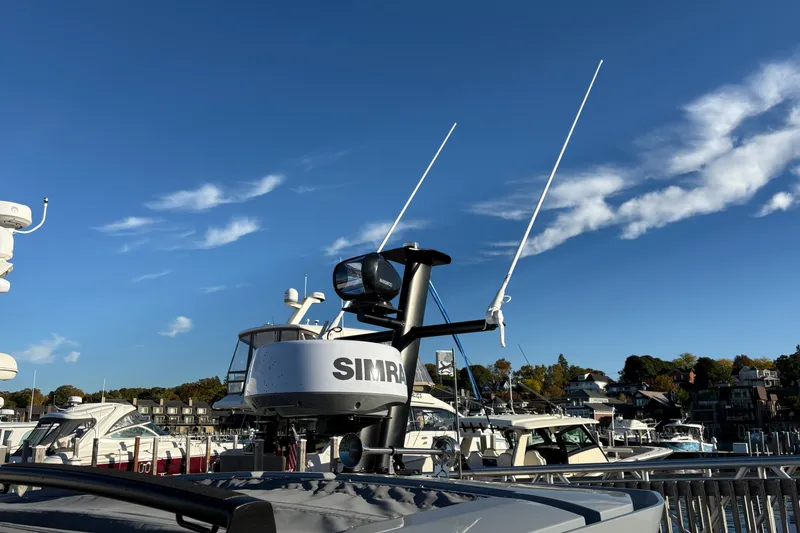 Slide: The Image of 2026 Axopar 29 XC Cross Cabin boat with radar and antennas in a marina. - 7
