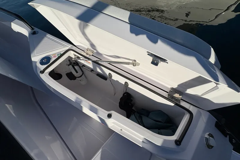 Slide: The Image of Open storage compartment on 2026 Axopar 29 XC Cross Cabin boat. - 25
