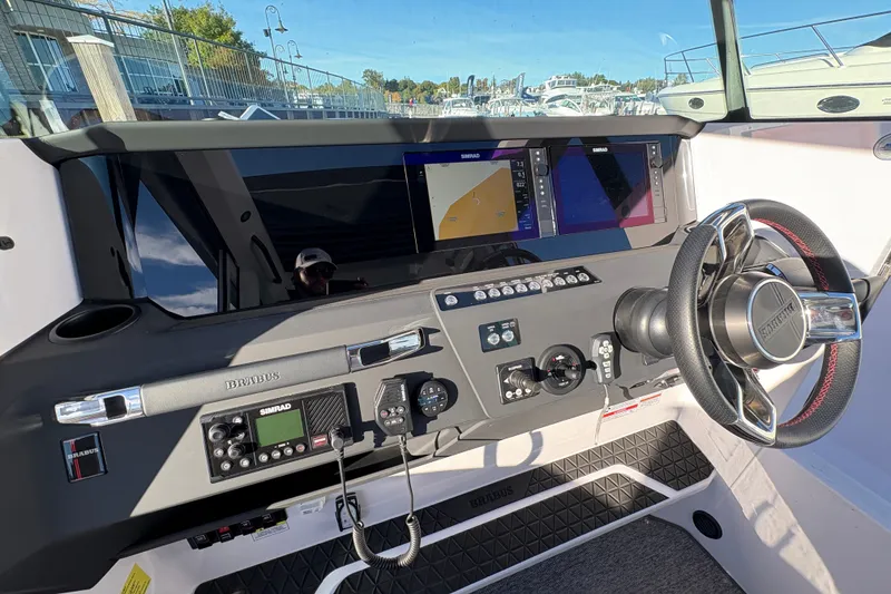 Slide: The Image of 2026 Axopar 29 XC Cross Cabin dashboard with steering wheel and navigation displays. - 18