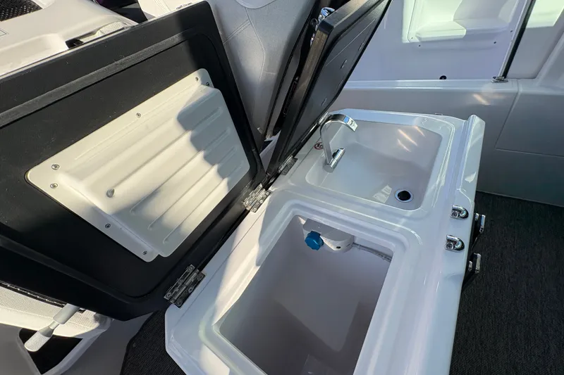 Slide: The Image of 2026 Axopar 29 XC Cross Cabin interior sink and storage compartment. - 21